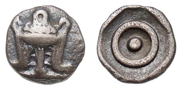 Coin of Delphi with the Omphalos ⊙ and Tripod.

Münzkabinett Berlin, Public domain, via Wikimedia Commons.