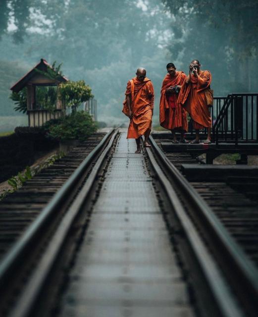 Monks on the train tracks of Thailand 