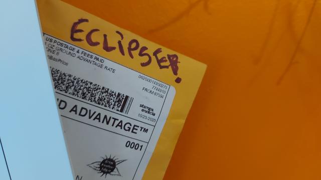 The corner of an envelope with the word "Eclipse!" written on it
