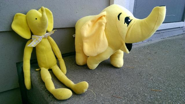 Two yellow elephant plush toys.