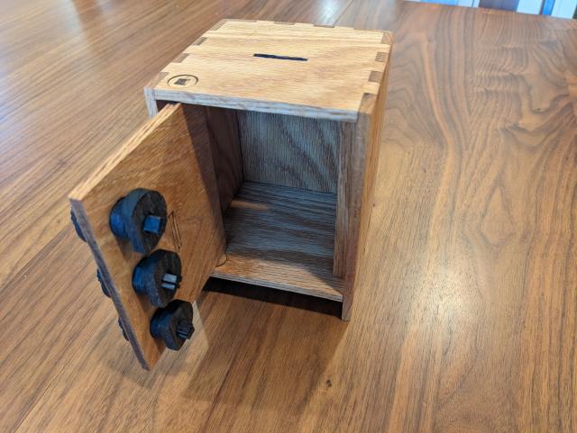 The same piggybank, this time with the door open and the locking mechanism visible.