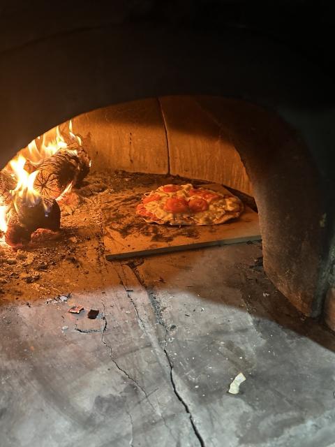 Homemade cheese + fresh tomatoes pizza in the Wood-burning oven