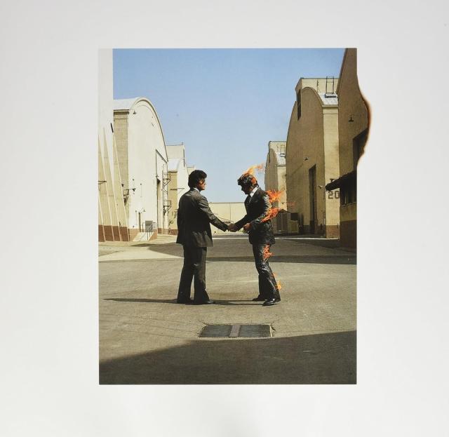 Wish You Were Here album cover, two dudes in suits shaking hands. One is on fire.
