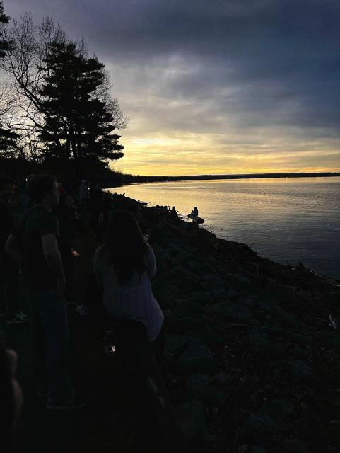 Eclipse photo taken at Verona Beach, NY. Darkened sky with lone figure in silhouette. 