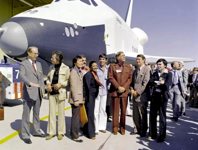 Standing in front of Space Shuttle Enterprise, Palmdale, California September 17, 1976:

NASA Administrator Dr. James D. Fletcher; DeForest Kelley; George Takei; James Doohan; Nichelle Nichols; Leonard Nimoy; Gene Roddenberry; U.S. Rep. Don Fuqua; Walter Koenig.