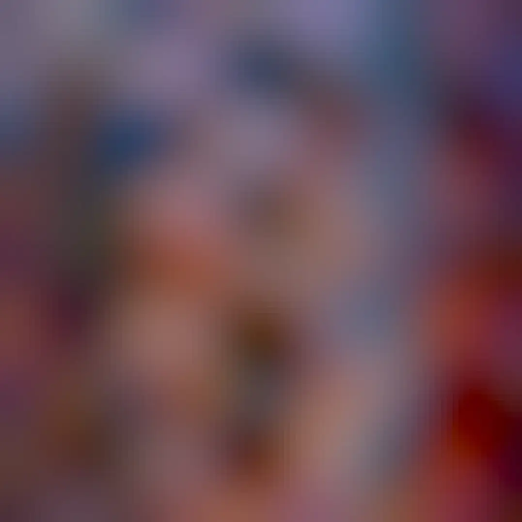 Complex filaments of many colors cross the image in front of a starry background. Some regions have a diffuse red or orange glow.