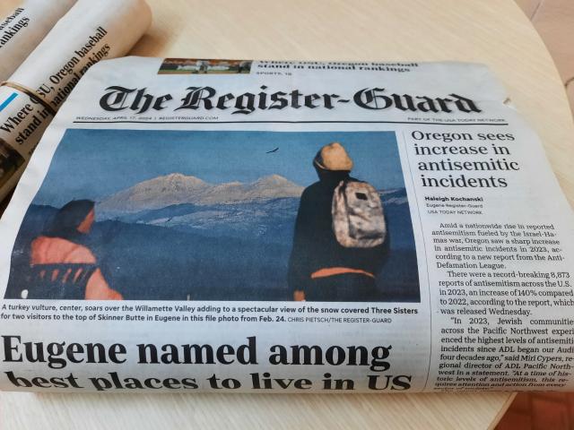 The front page of The Register Guard. Two articles can be seen. In the center is "Eugene named among best places to live in US," while just to the right is an article saying "Oregon sees increase in antisemitic incidents."