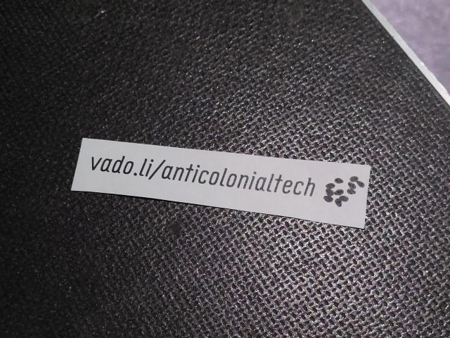 small paper strip with the url vado.li/anticolonialtech distributed all over the transmediale venue