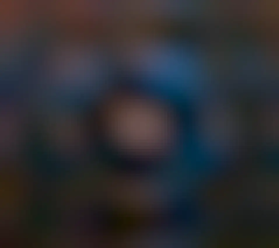 A blue star is seen in the center of a red nebula itself surrounded by a faint blue nebula. The surrounding starfield itself has a faint red-brown emission clouds.