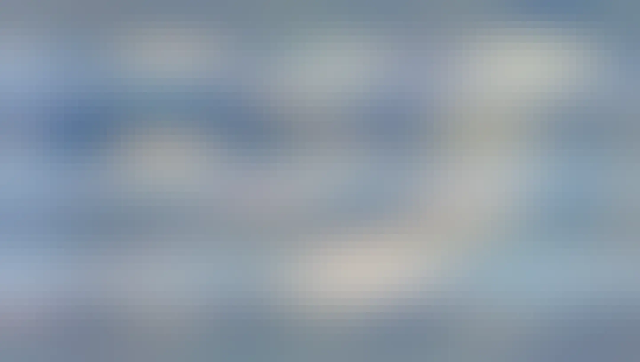 White clouds with tints of sunset colours, they perhaps look like whiffs of smoke (or thats what I thought on seeing them) but they might have been straight at some point and then wind distorted them. The sky is blue behind them, though photo taken at sunset. Kampala, Uganda.