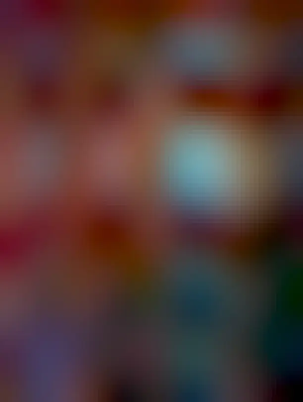 A colorful star forming region is shown that resembles a fish swimming to the right. Dark dust is apparent across the lower right, and a sparse starfield is visible all over the image.