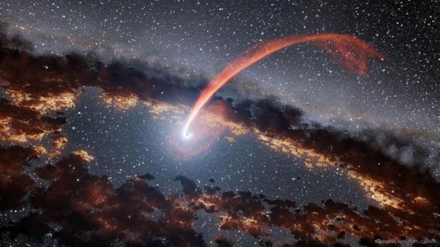 An illustration shows a small black dot in the center which is a black hole. A red stream or gas arcs in from the top. The black hole is also surrounded by a dark and dusty disk.