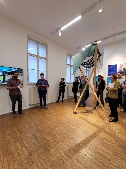A group of people standing in MAERZ Galerie during the exhibition's opening.