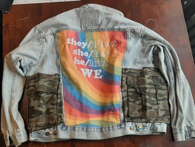 back of the levis pride jacket. it has a big rainbow back thingy that says 

they/them
she/her
he/him
we

and camo cargo pockets pinned into the sides
