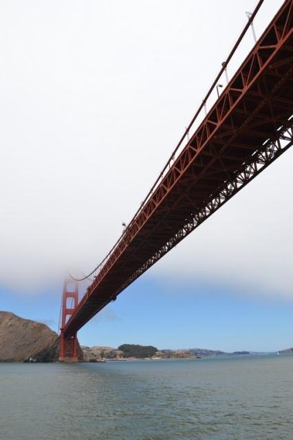 Golden Gate bridge, San Fransisco, partially covered in fog. Taken from the water. 