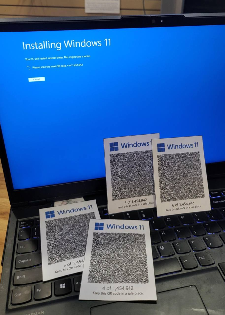 [four printouts of very large QR codes in front of a laptop]
Installing Windows 11
Your PC will restart several times. This might take a while.
Please scan the next QR code: 4 of 1,454,942