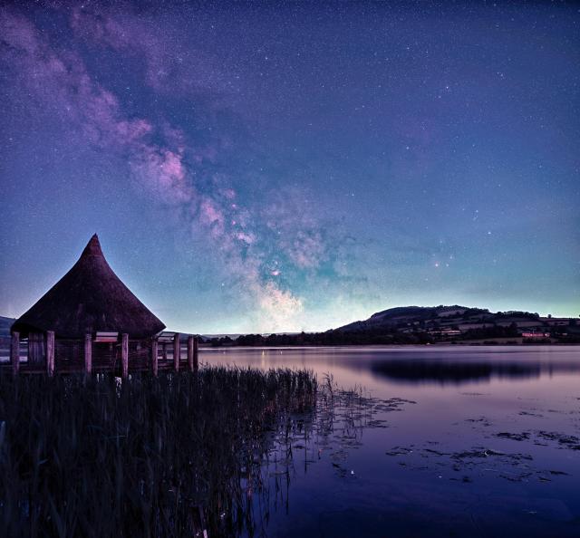 "Milky Way over the Crannog at Llangorse Lake, South Wales."

TheGasmanDruid, CC BY-SA 4.0, via Wikimedia Commons. Color edits.