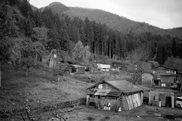Black and white film photo of Shirakawago village. 