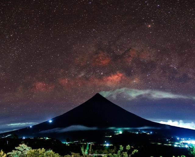 "Mayon Volcano with the Galactic Core."

Bien02, CC BY 4.0, via Wikimedia Commons. Color edits.