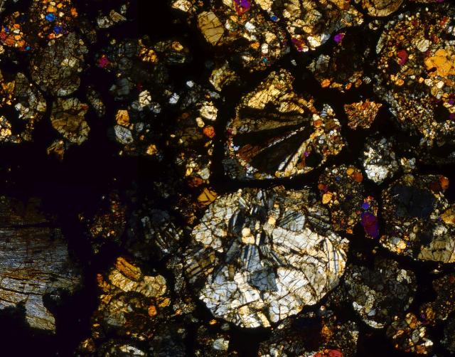 Northwest Africa (NWA) 4910 Meteorite Thin Section microphotograph.

Solar Anamnesis, CC BY-NC-SA 2.0 via Flickr: https://flic.kr/p/XxBtaP