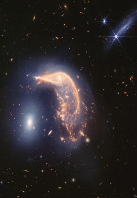 James Webb image of two galaxies resembling a pwng & an egg