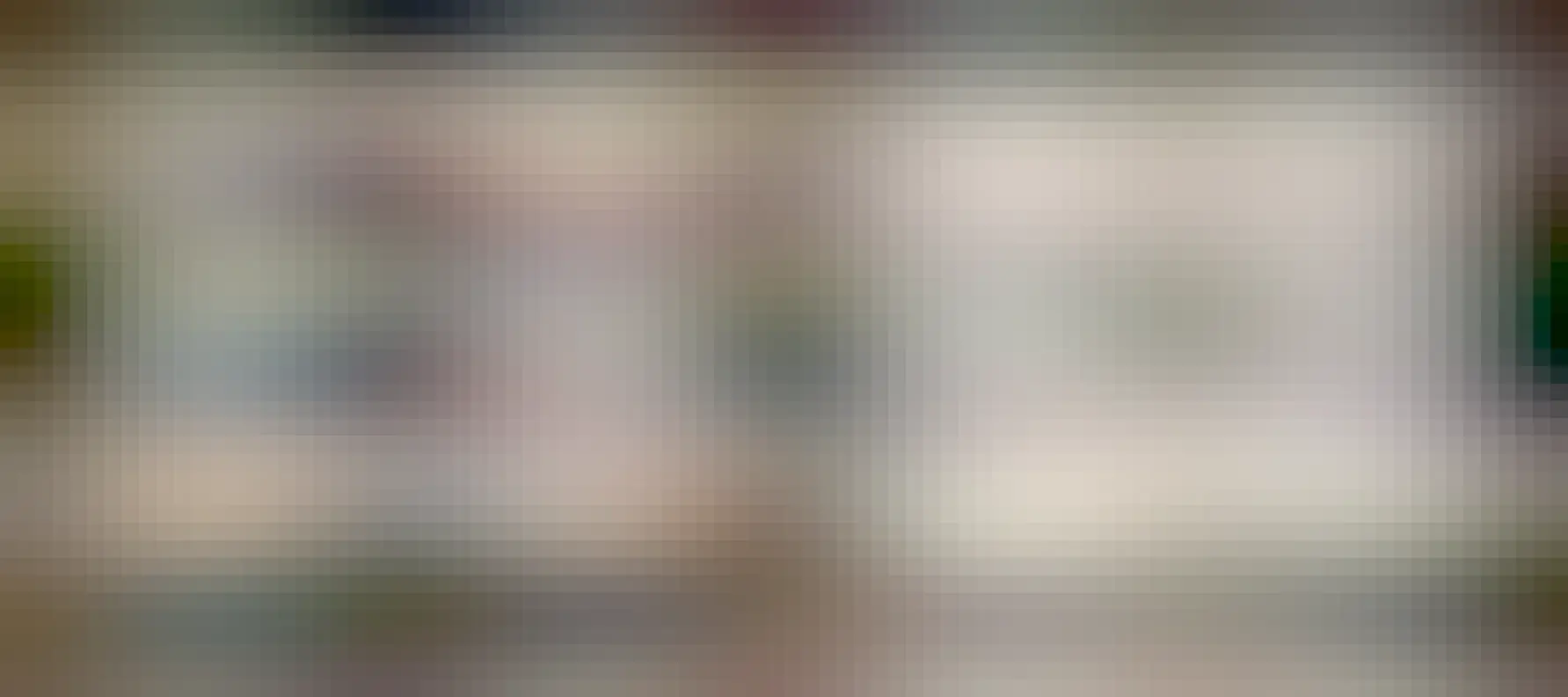 Two Framework 16 laptops. One (on the left) is covered in stickers and the other (on the right) is brand new, without any stickers.