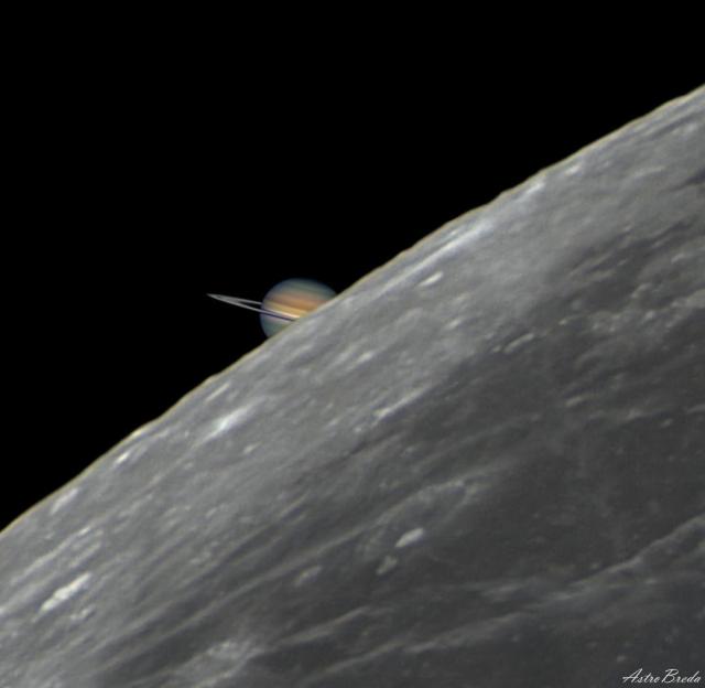 A picture of the edge of the Earth's familiar Moon takes up the right part of the frame, while a partial image of Saturn is visible just behind it on the left.