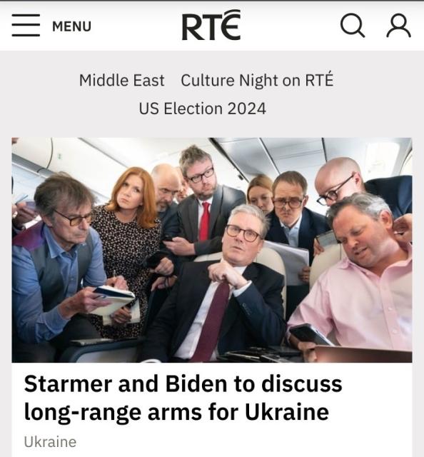 A headline from the RTE (Irish national broadcaster) website with the words 'Starmer and Biden to discuss long-range arms for Ukraine'. The image is a bizarre press photo with Starmer looking very confused, surrounded by a motley crew of advisors and people wearing strange expressions, all very white.