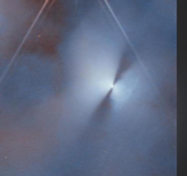 Section of original poster’s photo that appears to show a star with dark jets coming from it. The star doesn’t have the signature JWST six sided sparkles all the other stars show.