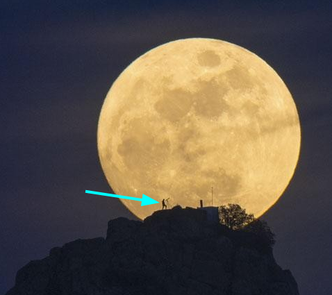 A picture of the moon behind a hill. A man is pointed with a cyan arrow over the picture