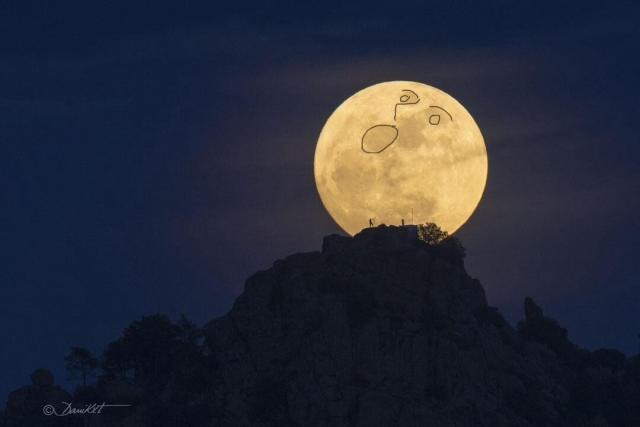 Photo from previous post of full moon but with a drawing of eyes, nose, and an open mouth as tho the moon is looking up in awe