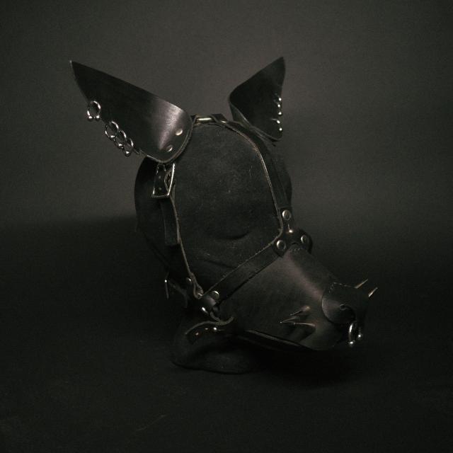 a puppy / beast leather mask in all black leather with some piercings