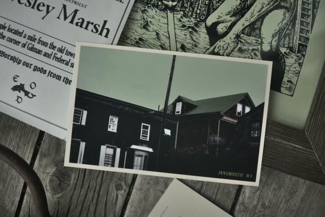 closeup of the postcard of innsmouth showing old shingle covered buildings