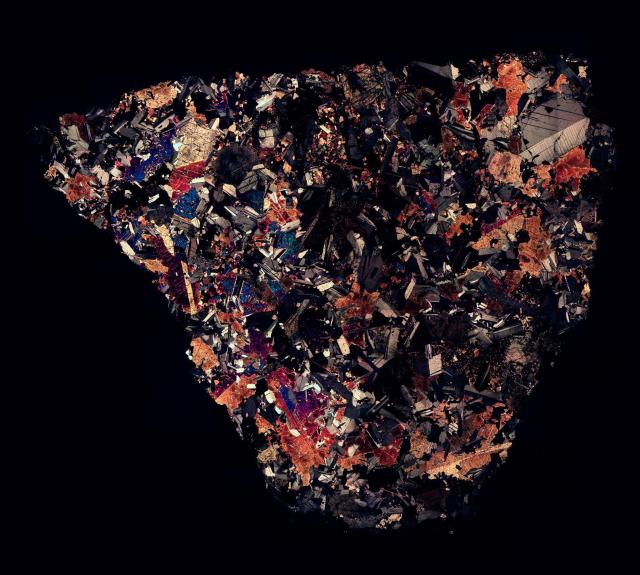 Northwest Africa (NWA) 5558 Meteorite Thin Section in Cross Polarized Light.

Solar Anamnesis, CC BY-NC-ND 2.0 via Flickr: https://flic.kr/p/NWFxqs