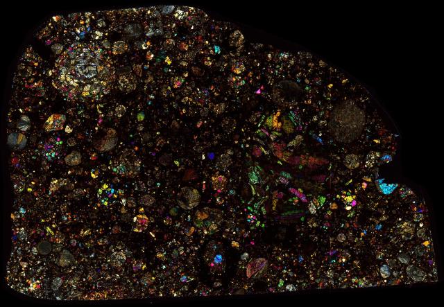 Northwest Africa (NWA) 5677 Meteorite Thin Section - XPL HDR Pathscan Enabler.

Solar Anamnesis, CC BY-NC-SA 2.0 via Flickr: https://flic.kr/p/2iGbHi8