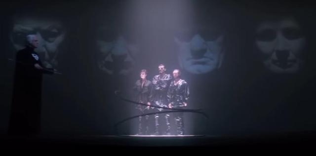 Jor-El looks on as two rings appearing to spin atop each other imprison General Zod and his associates.