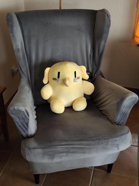 tje cute plush toy Mastodon on my IKEA Strandmon armchair.