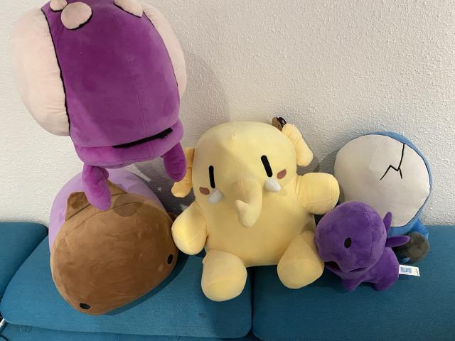 Mastodon plushi surrounded by Carbot Starcraft plushies. The zergling is nibbling at one foot, the spacemarine is behind the Zergling. On the left there is an Overlord floating above an Infestor.