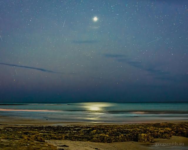 Venus, fairly low on the horizon, with its light reflected in the sea below.