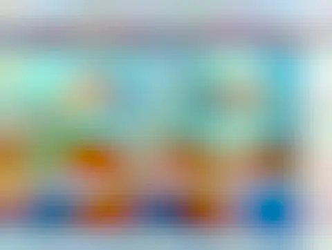 A colorful computer interface displaying a virtual desk for a financial management program. The screen includes sections for accounts, loans, investments, and various tools for managing money, surrounded by decorative elements like a clock and plants.