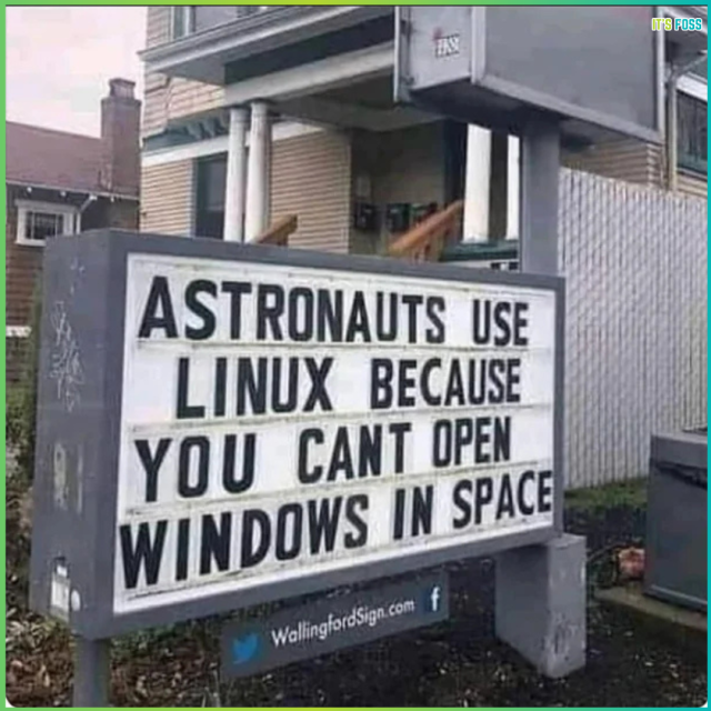 There is a board sign which says, “Astronauts use Linux because you can't open Windows in space”.