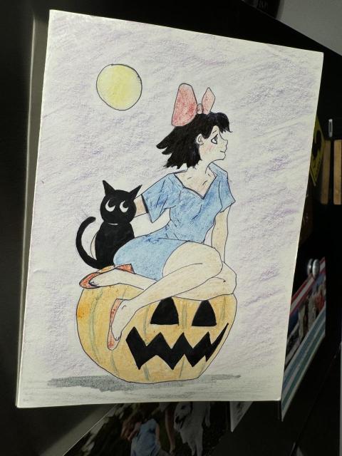 Kiki and her cat on a pumpkin from Kiki’s delivery service. Her hair is black.