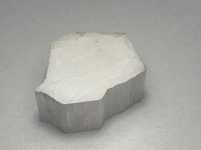 White translucent piece of mineral with a polished face