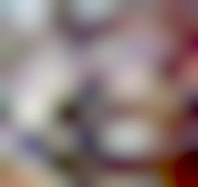 a couch that is also an enormous purple and white fluffy cow plushie with lovely horns and ears