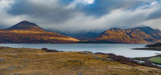 Dark shadows on golden hills.