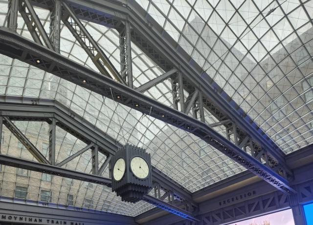 Ceiling of Penn Station with main clock hanging from the top.