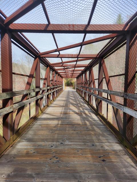 Looking down a bridge on a bike path