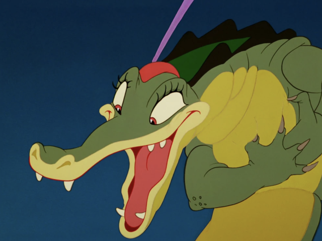 Ben Ali Gator from Fantasia grasps his chest over his heart and looks down at his love with bright eyes and happy open mouth.