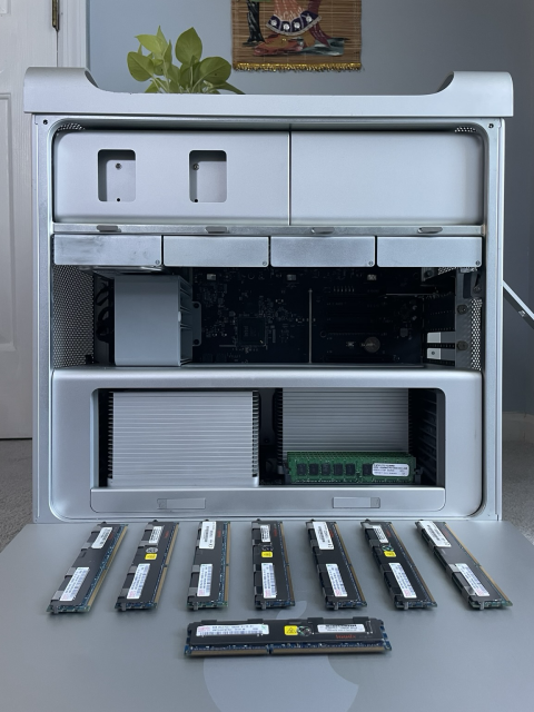 A computer tower with its side panel exposed and a kit of memory. 