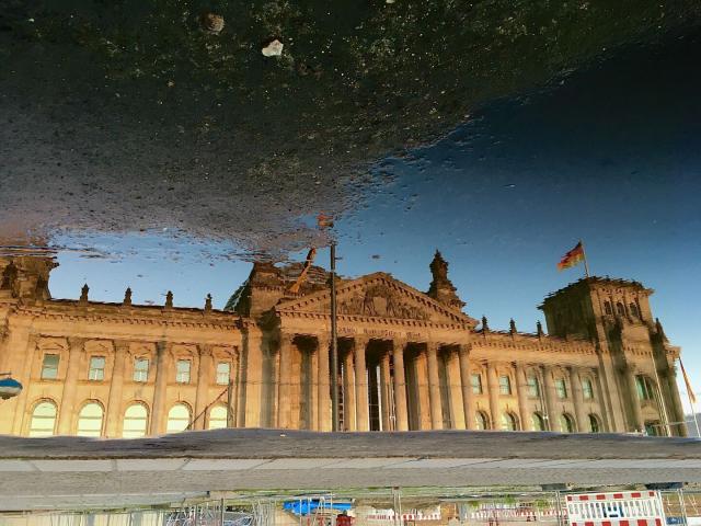 The German Bundestag as seen in a puddle’s reflection.